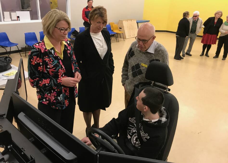 Member for Cootamundra Katrina Hodgkinson and NSW Minister for Roads Melinda Pavey with Young's Rotary Youth Director Frank Lincoln and Young's Adam Peddie, 20, at the Rotary driving simulator in Young this week.