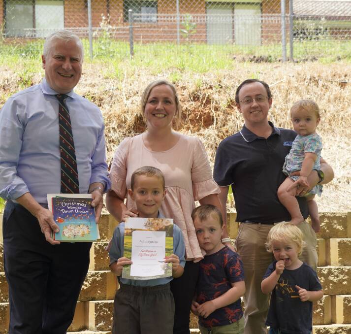 Member for Riverina Michael McCormack with St Raphael's student Isaac Symons and his family. Image supplied.