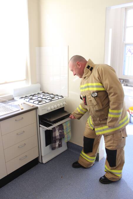 Cowra Station Captain, Chris Murray, keeps an eye on his cooking to highlight Fire and Rescue NSW's "Keep Looking when Cooking" message.