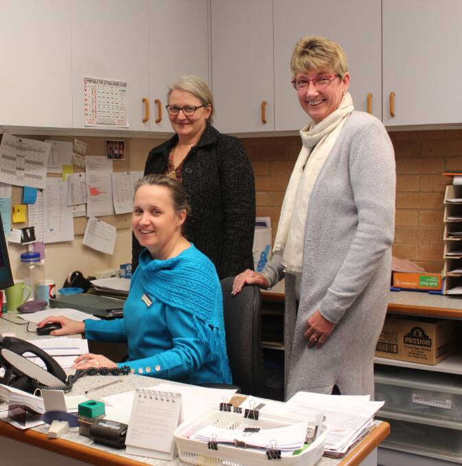Admin Officer Louise Hinderager working on the new computer system with the help of Admin Manager Anne Tree and Admin Officer Cathy Ellis.