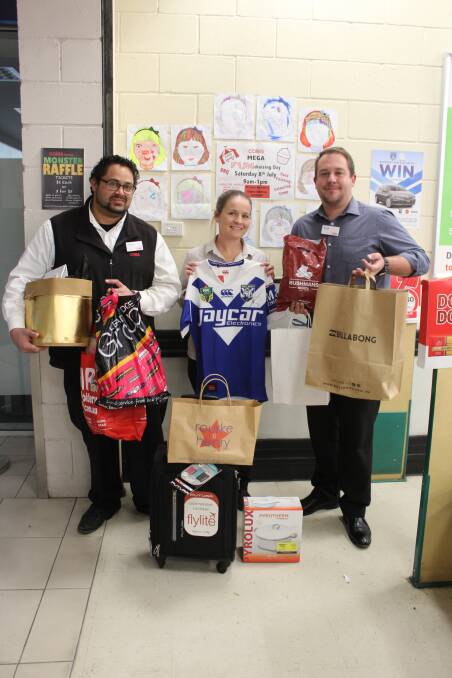 Coles Cowra team members Heylen Waqavesi, Nadia Cherry and Brook Kinsela with some of the prizes on offer at the Monster Raffle.